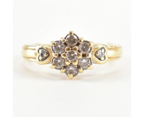 A hallmarked 18ct gold and diamond cluster ring. The ring being set with a cluster of round cut diamonds to the head and furt