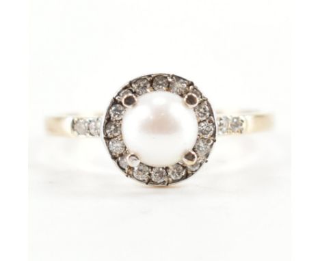 A hallmarked 9ct gold pearl and diamond ring. The ring set with a central cultured pearl with a halo of round cut diamonds an