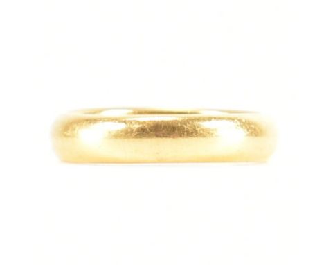 A hallmarked 22ct yellow gold band ring. The wedding band style ring of D form, hallmarked for Birmingham 1934, makers marks 