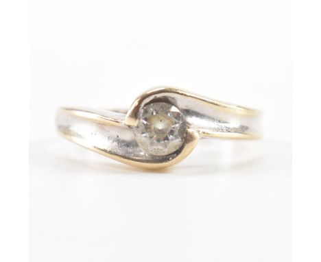 A hallmarked 18ct white gold solitaire ring. The engagement style ring having a central round cut white stone to a concave cr