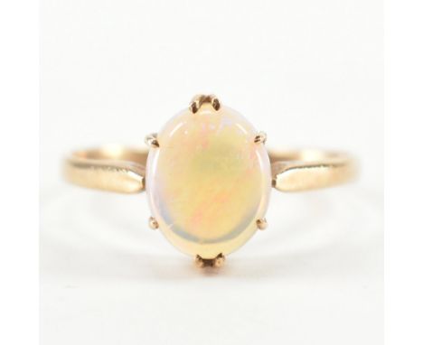 A vintage 9ct yellow gold &amp; opal single stone ring. The ring having an oval opal cabochon in prong basket setting to pinc