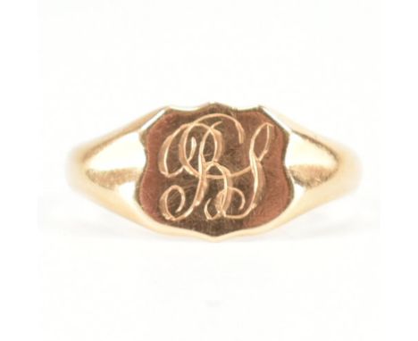 A hallmarked 18ct yellow gold signet ring. The ring having a shield head with etched monogram initials to dimpled shoulders &