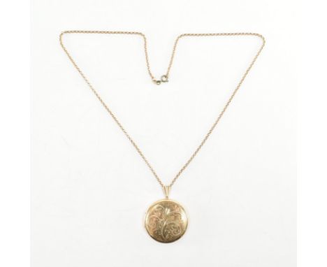 A hallmarked 9ct yellow gold locket pendant &amp; necklace chain. The locket of round form with etched detailing, hinged open