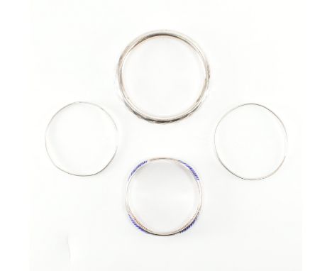 A collection of four silver bangles. The bangles to include a silver enamel decorated bangle marked 925 possibly Russian. Two