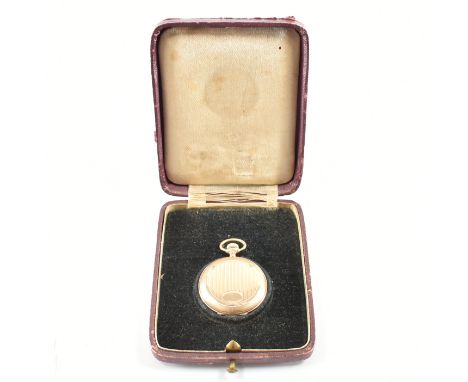 A 14ct gold Swiss gold fob watch. The watch having a white enamel dial face with blue enamel Arabic numerals. The case having