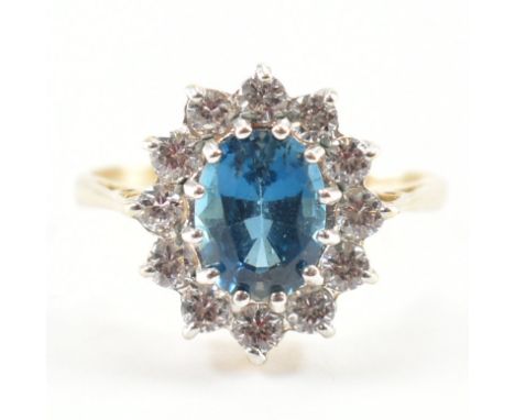 A hallmarked 9ct gold topaz and CZ&nbsp; cluster ring. The ring set with an oval cut Topaz hallmarked Birmingham. Weight 2.2g