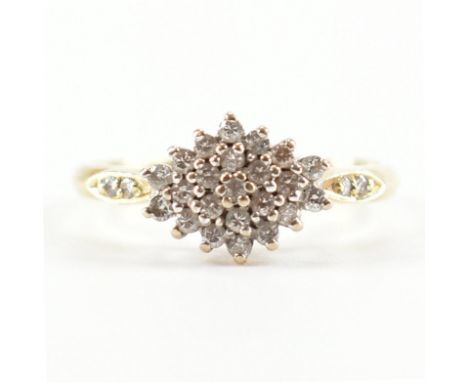 A hallmarked 18ct yellow gold &amp; diamond cluster ring. The ring having a cluster of round cut diamonds to a lozenge form h