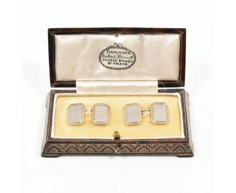 A pair of&nbsp; 1920s 18ct and 9ct gold cufflinks. The cufflinks in white and yellow gold with engine turned decoration marke