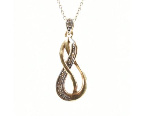 A hallmarked 9ct bicolour gold &amp; diamond necklace pendant together with 9ct yellow gold chain. The pendant in the form of