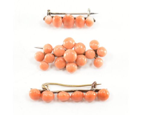 A group of three coral cabochon brooches. The first of floral formation with clustered peachy coral cabochons, the next havin