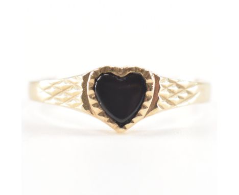 A hallmarked 9ct yellow gold &amp; black stone signet ring. The ring having a heart cut faceted bezel set black stone to cros