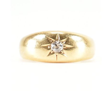 A hallmarked 18ct yellow gold &amp; diamond single stone ring. The dome ring having a central round cut star set diamond to t