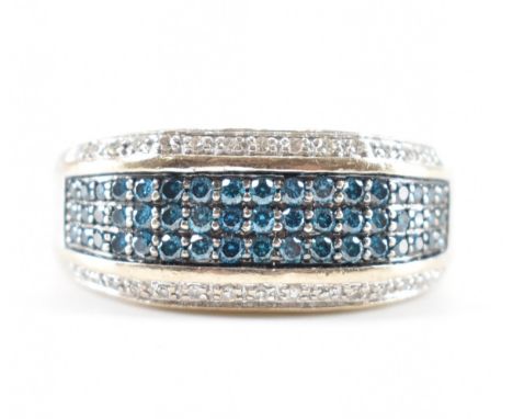 A white gold blue and white diamond ring. The ring having a central band of blue stones flanked by white accent stones either