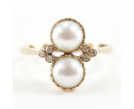 A hallmarked 9ct gold cultured pearl and diamond ring. The ring being set with two half pearls flanked by six round diamond a