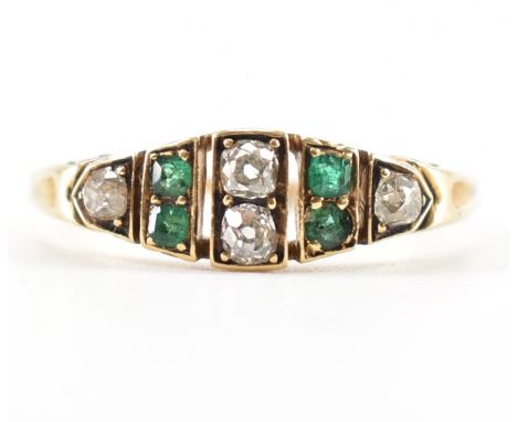 A Victorian emerald and diamond ring. The ring set with two central old cut diamonds flanked by mixed cut emeralds and old cu