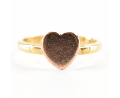 A Victorian hallmarked 18ct gold heart ring. The ring having a rose gold heart head to yellow gold straight shank with etched