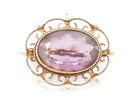 A hallmarked 9ct gold amethyst and pearl brooch pin. The brooch set with an oval cut amethyst framed by pearls having roller 
