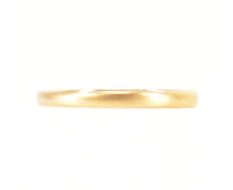 A Victorian hallmarked 22ct yellow gold band ring. The wedding band style ring of shallow D form. Hallmarked for Sheffield 18