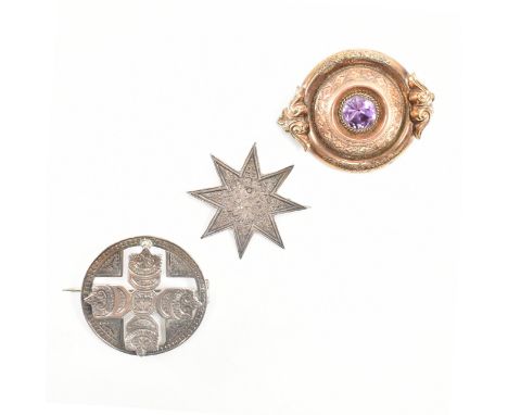 A group of three 19th Century Victorian brooches. The lot to include a silver star brooch with floral engraved detailing, a r