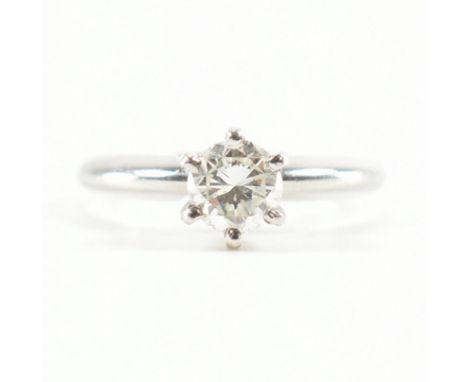 A 900 platinum &amp; diamond solitaire ring. The single stone engagement style ring having a round cut six prong set diamond 