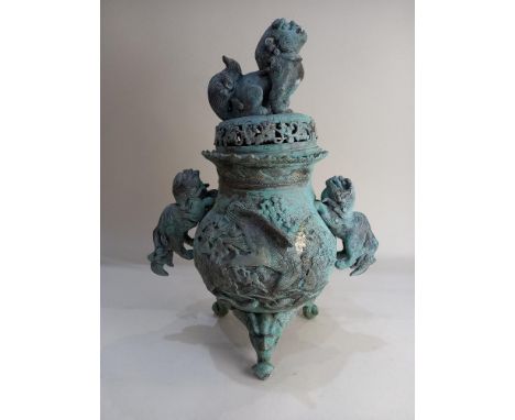 A Chinese metal censer, green patina, the lid with Dog of Fo finial, on three feet 47cm high (a/f)