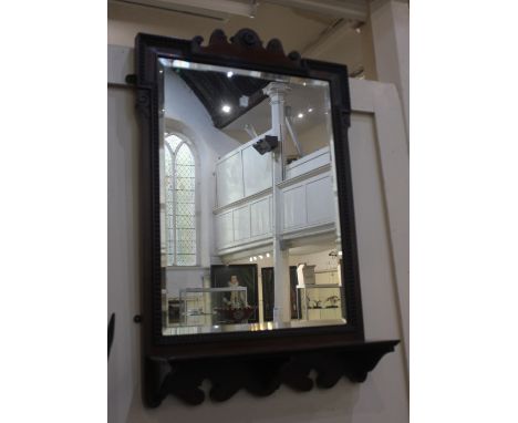 A late 19th / early 20th century mahogany framed wall mirror with bevelled glass above a rectangular shelf, mirror plate 60cm