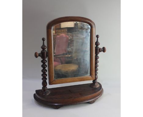 A Victorian dressing table mirror arched glass on bobbin turned supports and curved base, 48cm