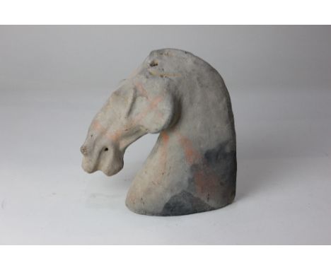 A Chinese pottery model of a horse head, possibly Han Dynasty, of stylized form, 19cm high 