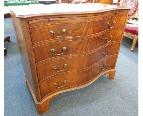 A mahogany serpentine chest of four graduated drawers with brushing slide and brass drop handles, on bracket feet (a/f) 109cm