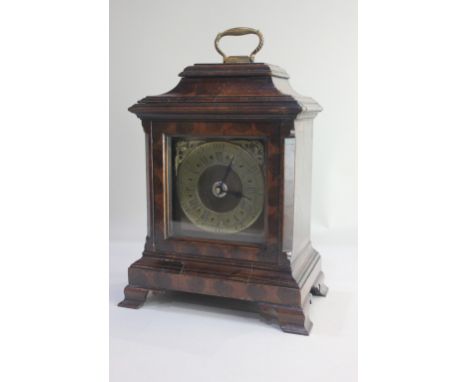 A George III style oyster veneered mantle clock case with brass carry handle, chapter ring and replaced battery movement, on 