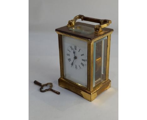 A brass carriage clock white dial with Roman numerals 15cm