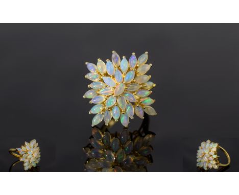 Ethiopian Opal Cluster Ring, a cluster of marquise cut opals set in a squared starburst formation, raised above a cage style 