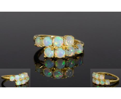 Ethiopian Opal Crossover Ring, eight round cut opals, totalling 1ct, set in a horizontal crossover, in 14ct gold vermeil and 