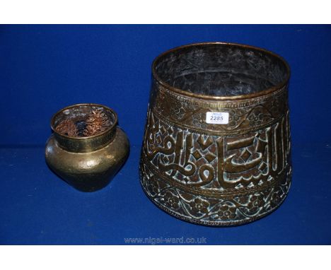 A large 19th c. Islamic/Turkish brass Planter of tapering form with repousse Islamic lettering, 30cm tall x 26 cm diameter an