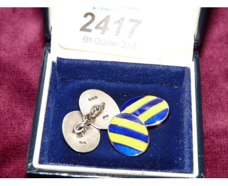 A pair of gold/blue enamel on silver cufflinks