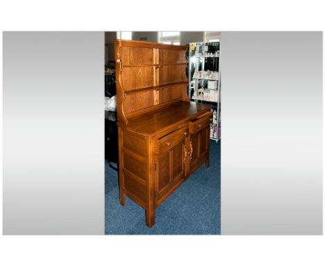 Ercol Cottage Dresser & Rack, Two cupboards below two drawer base, panelled back plate rack with two shelves, Light oak colou