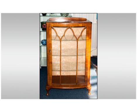 1930's Walnut Veneered Single Door Display Cabinet with arch shaped astral glazed doors to the front with a bow front. Termin