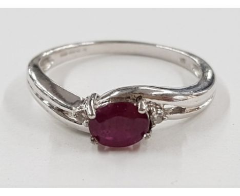 9CT WHITE GOLD OVAL RUBY STONE RING WITH TWO SMALL DIAMONDS, 2.5G GROSS SIZE N1/2