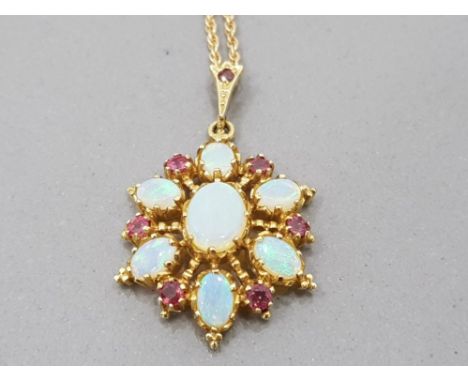 A 9CT YELLOW GOLD OPAL AND RUBY PENDANT ON 9CT GOLD CHAIN 6.6G GROSS