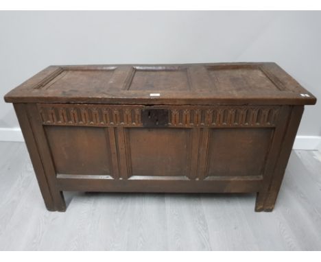 AN ANTIQUE OAK COFFER WITH LATER CARVED PANEL 120.5 X 63 X 49CM