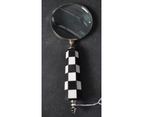 A 20th century vintage style hand held magnifying glass with checkerboard handle with shaped metal detail to end. It measures