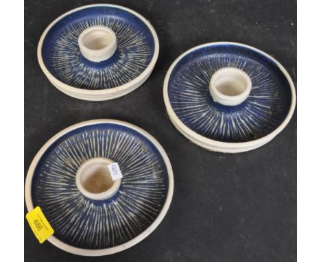A collection of three vintage retro 20th century studio pottery candlestick holders having blue scratch glaze to surface. Ove