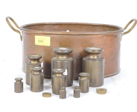 A set of early 20th century copper twin handled planter, together with a set of Avery grocers scales. Measures 33cm length.