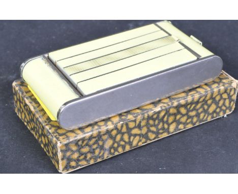 An early 20th century circa 1930s Art Deco painted metal compact having a fall front cigarette holder section with powder / b