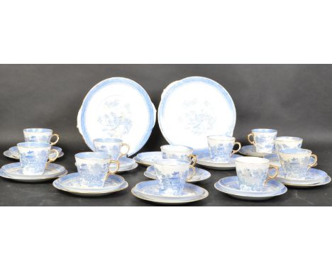 An early 20th century bone china willow pattern tea service. The service comprising of teacups, saucers and side plates. Each