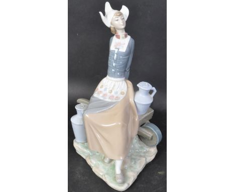 Lladro - A vintage 20th century Spanish porcelain Lladro figurine in the form of a Dutch Milkmaid with wheelbarrow and milk c