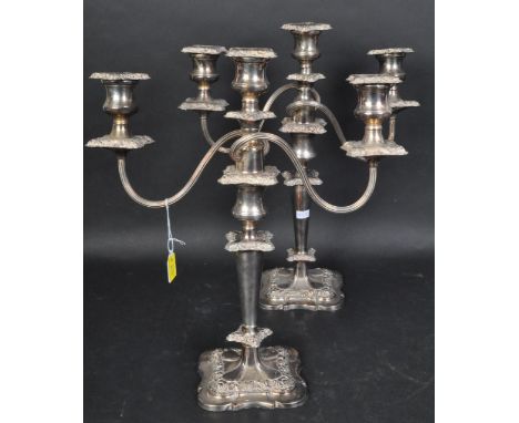 A pair of vintage 20th century silver plated candlestick candelabra. Each having two arms with moulded foliate education, rai