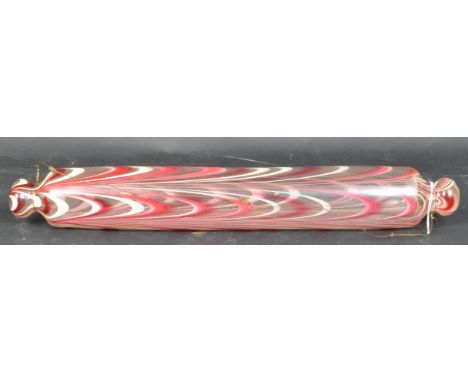 A Victorian 19th century Nailsea glass rolling pin with textured bright pink &amp; white striped decoration. It measures appr