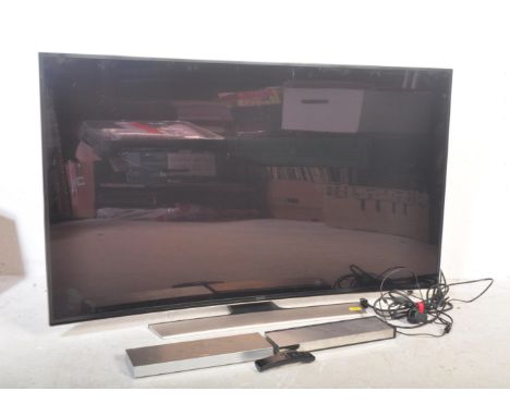 A contemporary Samsung 55 inch curved TV / television model no UE55HU8500T raised on a silvered base.&nbsp;