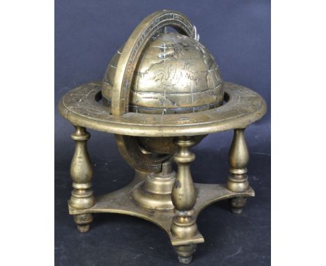A vintage 20th century solid brass desk top spinning globe on stand having engraved details and baluster supports. Measures 2